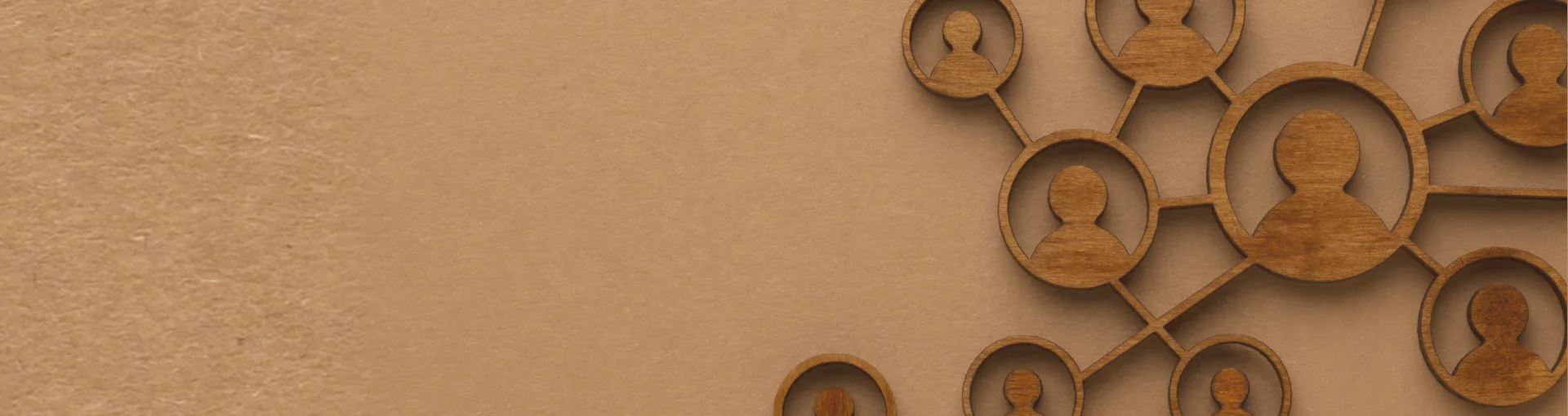 Interlinked wooden human icons symbolizing unity, connection, and shared vision among the TrustScape Medical Services core team.